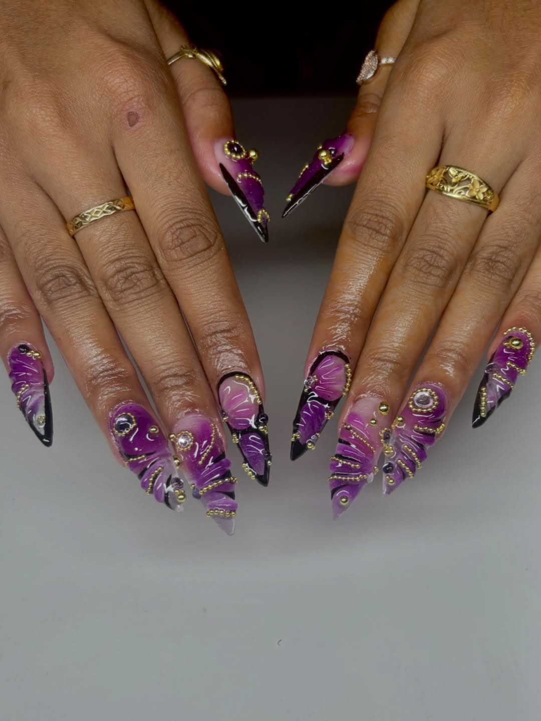 Purple Stiletto Nails With Gold Chains And Dark Borders