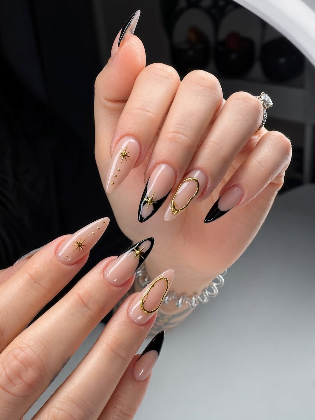 Stiletto Nails with Black French Tips and Stars