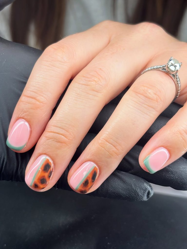Soft Pink Nails With Minimal Green Tips and Animal Print Accents